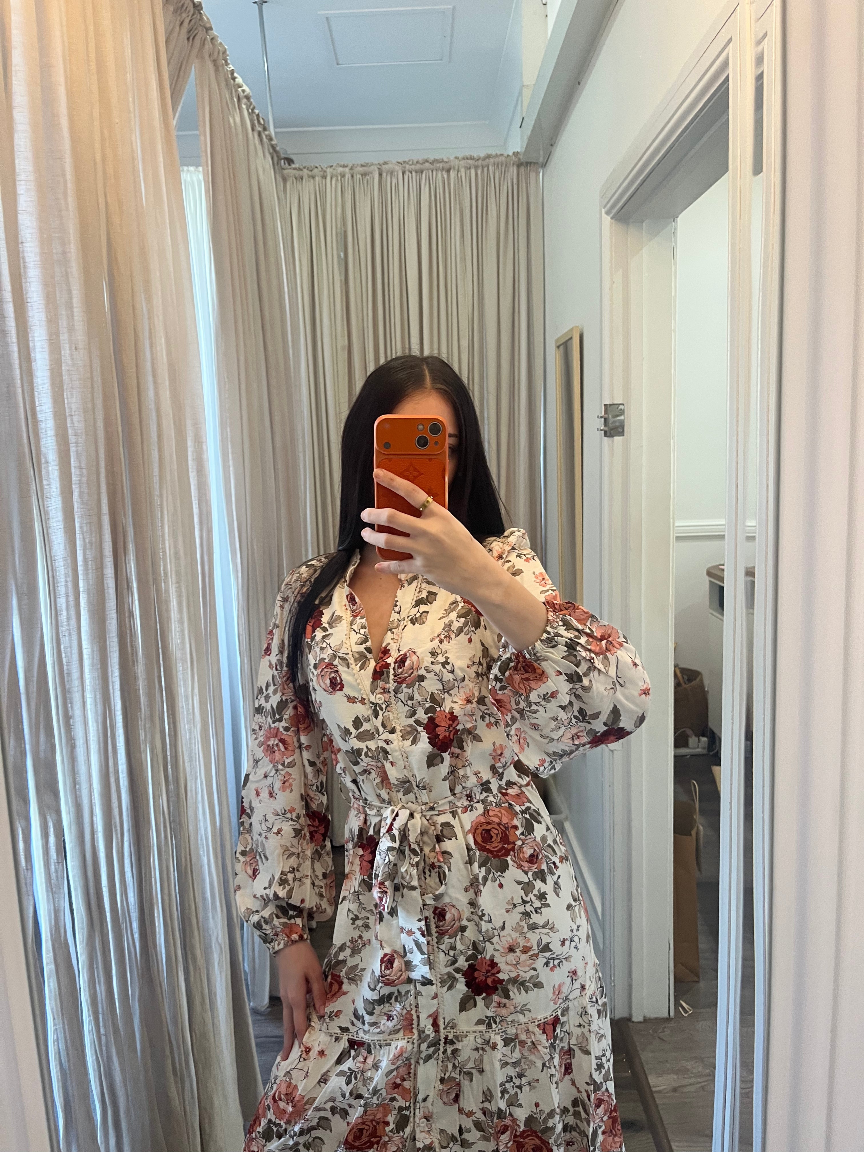 Woman wearing the Autumn Bloom Floral Tie Waist Midi Dress with an autumn floral print and adjustable waist tie.