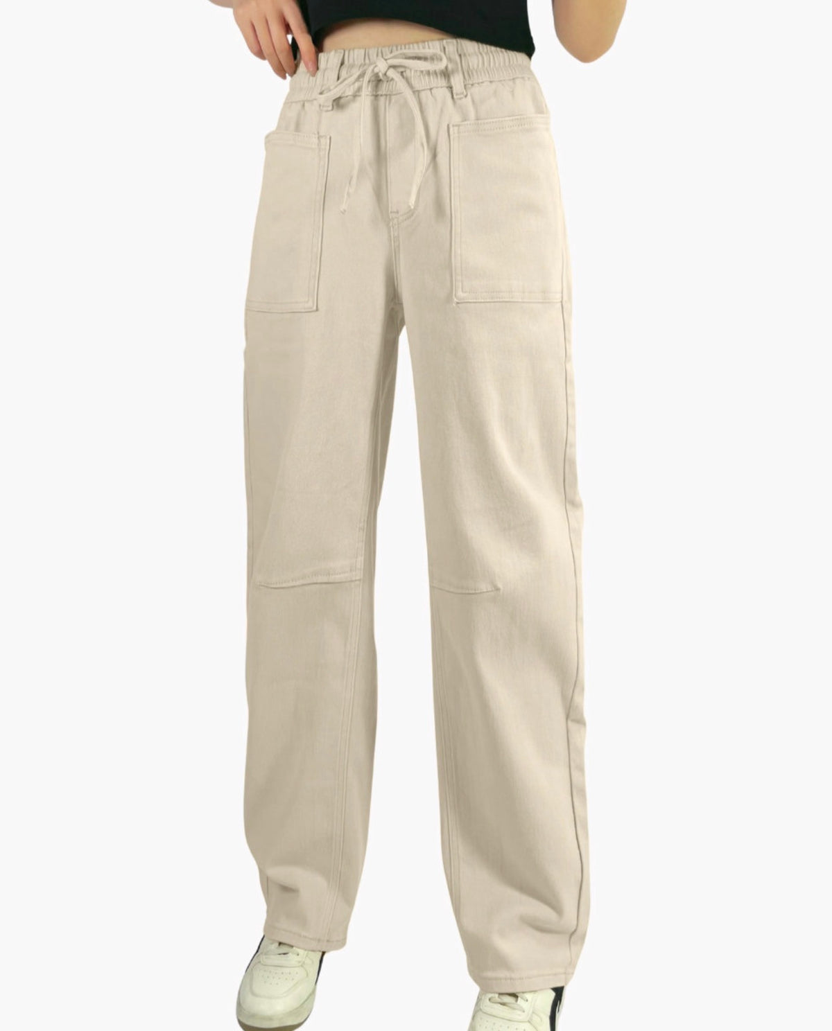 Beige pants worn by a person on a white background