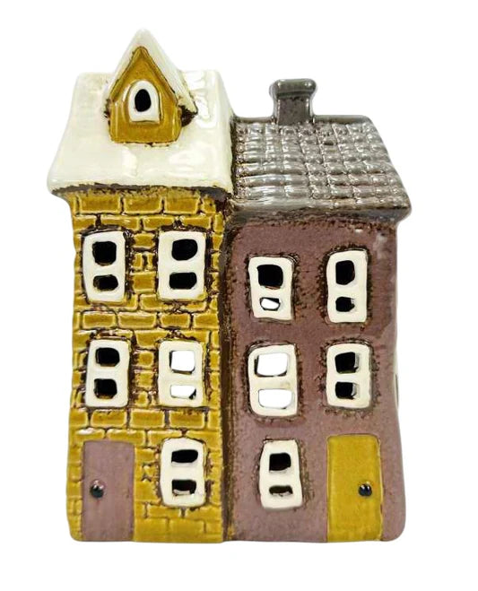Two small model houses with different colored facades on a white background