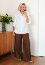 Women’s white linen shirt styled with denim casual outfit