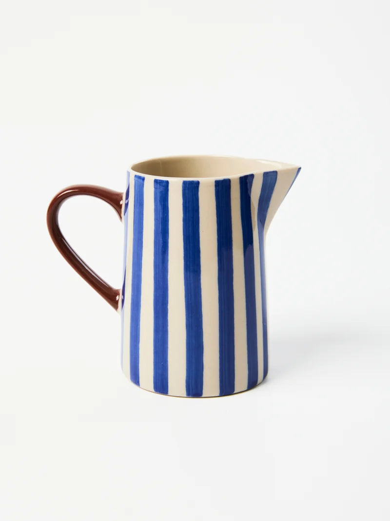 Striped blue earthenware milk jug for coffee and tea serving
