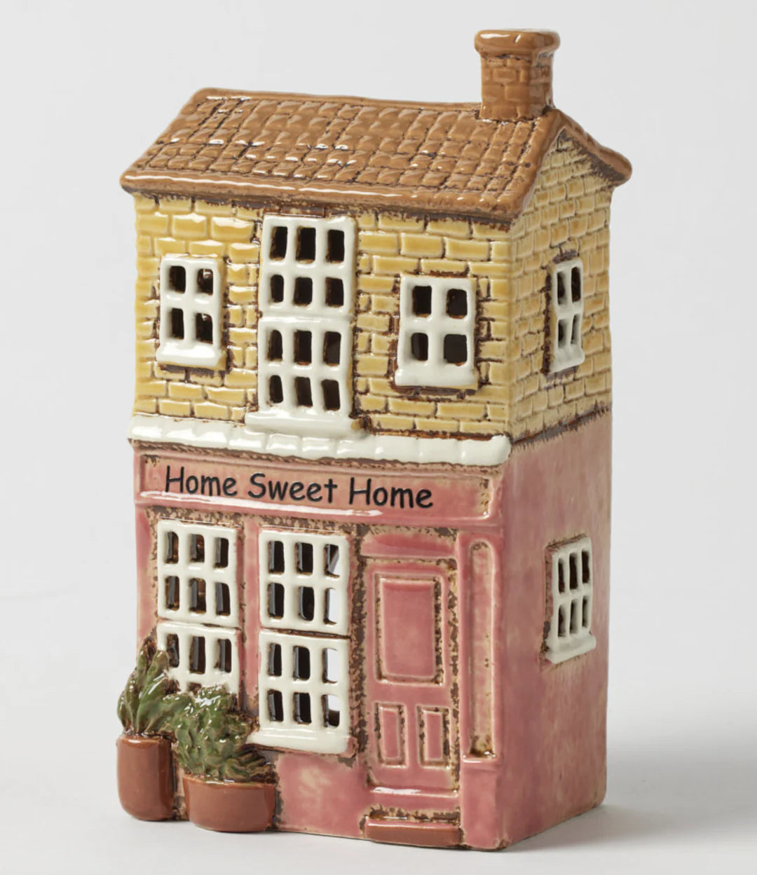 Hand painted townhouse tealight holder blush tones glowing windows ceramic décor